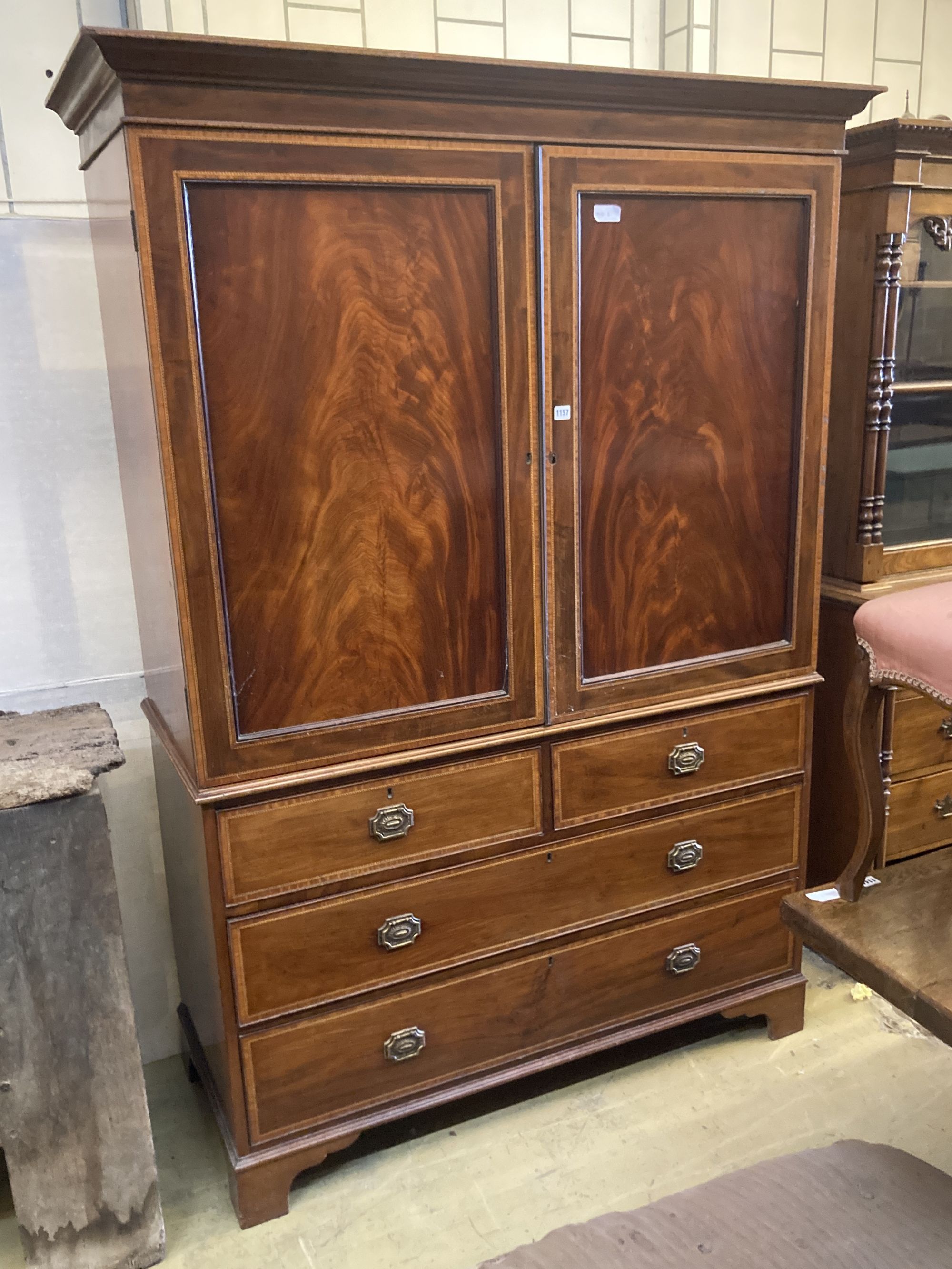 A George III style satinwood banded mahogany linen press, length 136cm, depth 59cm, height 200cm